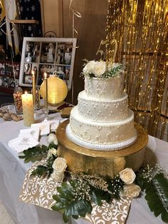 a white wedding cake sitting on top of a table