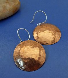 Named for the third largest planet in our solar system, the "Queen Neptune" earrings measure a whopping 1 1/4 inches in diameter.  These are for the adventurous girl who loves her earrings big! These earrings dangle boldly and shimmer in the sunlight (even on a cloudy day)!  Hand-cut from copper sheet, these earrings are 100% handmade. First, I use my favorite hammer to pattern the metal. Each disc is then subtly domed in a convex shape that hangs beautifully from my handmade sterling silver ear wires.  Finally, each copper disc is sealed with a clear lacquer to preserve it's shiny finish. All Dream Spiral Art Jewelry is handmade with love in my home studio that is located on the sunny side of a 100 year-old farmhouse in the woods of Virgina. Additional sizes and styles can be found here: Donut Earrings, Metal Jewelry Making, Spiral Art, Earrings Big, Modernist Jewelry, Copper Sheets, Disc Earrings, Our Solar System, Hammered Copper