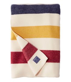 a striped towel folded on top of a white table with a red, yellow and blue stripe