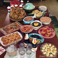 a table filled with lots of food and drinks on it's side, including desserts