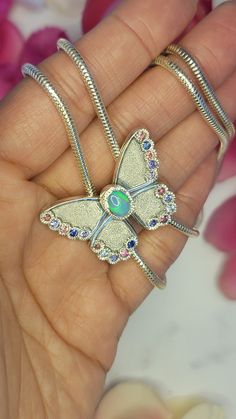 Butterfly Bolo Necklace  This butterfly bolo necklace is gorgeous.  The butterfly was form by melting scrap sterling silver and pressing it into a vintage impression die.  I chose a very flashy opal for its body.  The 8x6 mm opal was set in my signature textured bezel.  I then set 20 (2mm) sapphires on the butterfly's wings.  The chain is a 2.5 mm sterling silver snake chain.  This necklace is 30 inches long.  This necklace is just like a traditional bolo, it slips over the head.  So please meas Unique Butterfly Charm Pendant Jewelry, Unique Sterling Silver Jewelry With Butterfly Charm, Sterling Silver Jewelry With Butterfly Clasp, Silver Sterling Silver Jewelry With Butterfly Clasp, Butterfly-shaped Gemstone Jewelry For Anniversary, Butterfly Gemstone Jewelry For Anniversary, Gemstone Butterfly Jewelry For Anniversary, Luxury Silver Jewelry With Butterfly Charm, Luxury Silver Butterfly Jewelry