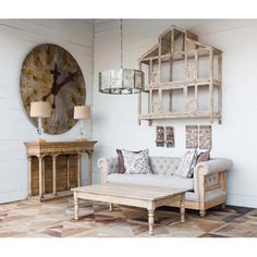 a living room filled with furniture and a large clock hanging on the wall above it