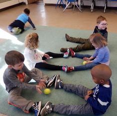 children sitting on the floor playing with balls