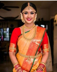 a woman in an orange and yellow sari