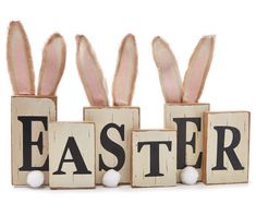 three wooden blocks spelling the word easter with bunny ears