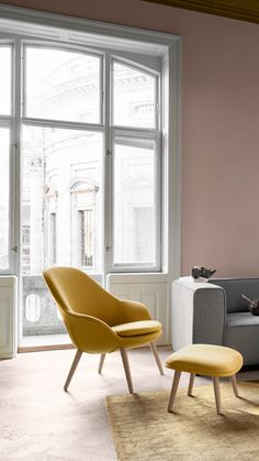 a living room with pink walls and furniture