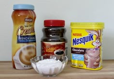 ingredients to make ice cream sitting on top of a wooden table next to each other