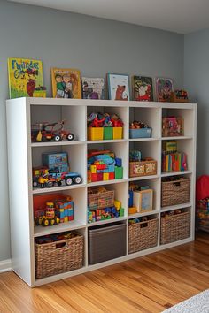 a white bookcase filled with lots of toys on top of a hard wood floor