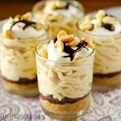 four desserts in small glass dishes on a table