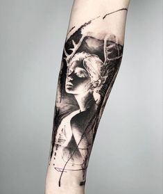 a woman's arm with a black and white tattoo on the left side of it