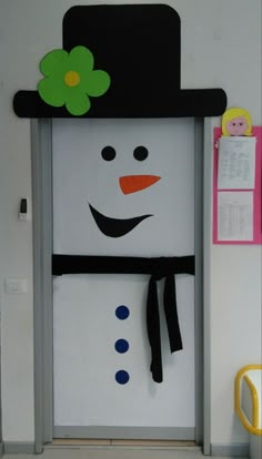 a door decorated with a snowman's hat and scarf