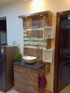 a bathroom with a sink, refrigerator and cabinets next to each other in the room