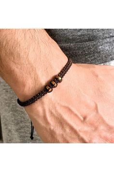 Elevate your style with our Handmade Unisex Macrame Weave Bracelet, featuring natural copper-colored hematite stones. This meticulously crafted accessory blends elegance with a touch of earthy charm, making it the perfect gift for yourself or a loved one. The adjustable macrame design ensures a comfortable fit for any wrist, while the shimmering hematite stones add a subtle yet striking accent. Embrace the harmony of handmade artistry and natural beauty--add this unique bracelet to your collecti Spiritual Brown Beaded Bracelets With Adjustable Cord, Brown Beaded Bracelet With Sliding Knot For Gift, Casual Brown Braided Bracelets With Round Beads, Adjustable Gold Beaded Copper Bracelets, Brown Bracelets With Adjustable Cord And Round Beads, Brown Macrame Braided Bracelet With Round Beads, Casual Brown Macrame Beaded Bracelet, Adjustable Brown Copper Braided Bracelets, Casual Brown Macrame Bracelets