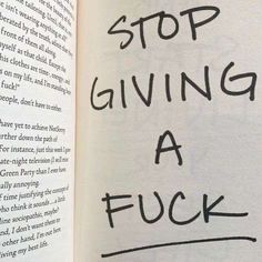 an open book with the words stop giving a f k written on it in black ink