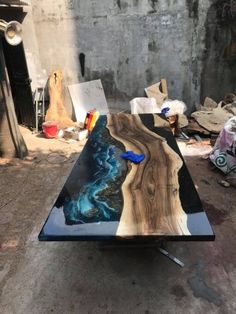 a table that is made out of wood and has an artistic design on it,