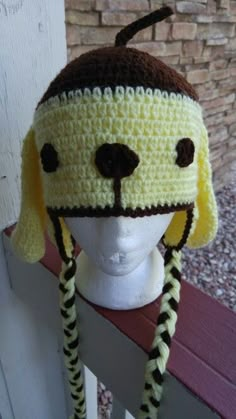 a crocheted dog hat on top of a white mannequin head