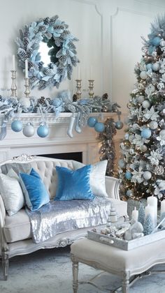 a living room decorated for christmas with blue and silver decorations