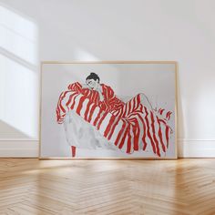 a painting is hanging on the wall in an empty room with wooden floors and white walls