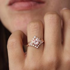 a close up of a person's hand with a ring on their finger and an oval shaped diamond in the middle