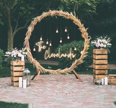 an outdoor ceremony with candles and wreaths