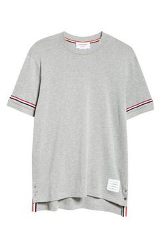 Thom Browne's varsity-stripe motif brings the label's signature refinement to a classic cotton T-shirt updated with a subtle high-low hem shut with buttons. 29" length (size 2) Crewneck Short sleeves High-low hem with button side vents 100% cotton with 97% cotton, 3% elastane trim Dry clean or machine wash, tumble dry Made in Italy Designer Clothing Classic Short Sleeve Tops With Striped Cuffs, Relaxed Fit Crew Neck Top With Striped Cuffs, Classic Cotton T-shirt With Striped Collar, Classic Crew Neck Top With Signature Stripes, Relaxed Fit Crew Neck Top With Signature Stripes, Cotton Crew Neck Tops With Striped Cuffs, Sporty Crew Neck Top With Striped Collar, Classic Crew Neck Top With Three Stripes, Sporty Top With Striped Collar And Crew Neck