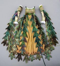 a piece of art made out of leaves and feathers