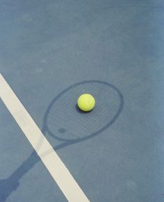 a tennis ball and racket on a court