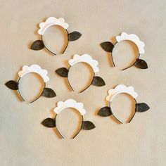 six pieces of paper cut out to look like sheeps with leaves on their ears