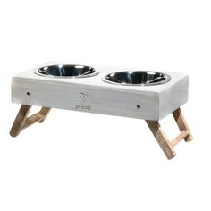 two dog bowls are sitting on a wooden stand that is made out of wood and metal