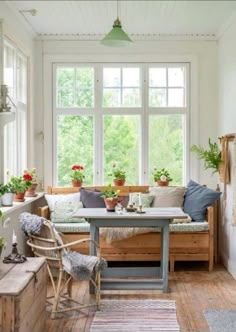 a living room filled with lots of furniture and plants on top of it's windowsill