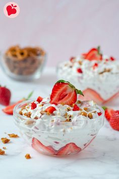 two dessert dishes with strawberries and whipped cream