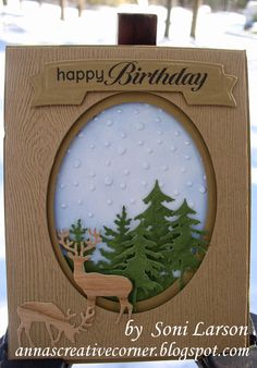 a handmade birthday card with an image of a deer and trees in the snow