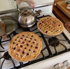 two pies are sitting on top of the stove