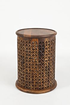 a wooden table with intricate carvings on the top and bottom, against a white background