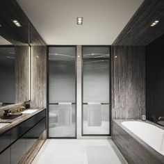 an elegant bathroom with marble walls and flooring, along with a large bathtub