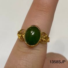 Gold colored ring with gold hearts on each side of a medium jade colored stone. Vintage ring inventory form my great grandmother's restaurant and gift shop in Silverton, CO that she owned and operated from the 1960s to 1996. Style 1358SJP Sizes available: Size 4 - qty 1 Size 4.5 - qty 2 Size 5 - qty 2 Size 5.5 - qty 1 Size 6 - qty 1 Size 6.5 - qty 2 Size 7 - qty 1 Gold Jade Emerald Ring, Gold Jade Cabochon Rings, Jade Rings Oval Cabochon For Anniversary, Gold Rings With Jade Cabochon, 1996 Style, Gold Color Ring, Gold Hearts, Colored Stone, Color Ring