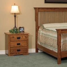 a bedroom scene with focus on the bed and nightstand, which has a night stand next to it