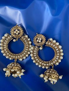 This beautiful antique style polished pair of earrings embellished with pearls and stones perfect accessory goes with any dress.  Necklace not included  Pls note that this set doesn't come in box but it will carefully be bubble wrapped before shipping.  For any other information pls feel free to text. Happy Shopping 😃 Festive Metal Chandbali Jhumkas, Festive Chandbali Metal Jhumkas, Metal Chandbali Jhumkas For Celebration, Festive Bollywood Bridal Earrings In Metal, Festive Bollywood Style Metal Chandbalis, Festive Bollywood Metal Chandbalis, Bollywood Style Heavy Metal Chandbalis, Heavy Metal Bollywood Chandbalis, Bollywood Style Metal Jhumkas With Intricate Design