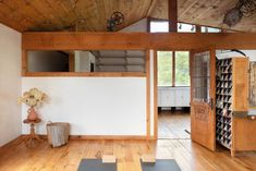 an empty room with wood floors and white walls is shown in this image, there are several shelves on the wall