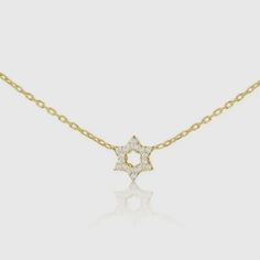 This is a pre-order item and will ship within 7-10 business days. The hint of sparkle, the diamonds and gold lay softly on your chest. This dainty Star of David necklace is ideal for anyone looking to add a pop of sparkle and a pendant full of love, hope, and faith. 14k goldSet with 6 full cut diamonds weighing .06ct total weight 16" chain with 2" extender Choose from white, rose, or yellow gold Star Pendant Size: 1/4" 14k Gold Star-shaped Necklace With Diamond Accents, 14k Gold Star Necklaces With Diamond Accents, 14k Gold Star Necklace With Single Cut Diamonds, 14k Gold Star Diamond Necklace Gift, Gift Diamond Necklace With Star Of David Accents, Gold Star-shaped Necklace With Single Cut Diamonds, Dainty Star-shaped Diamond Necklace For Gift, Diamond Necklace With Star Of David Charm For Gift, Star Of David Necklace With Single Cut Diamonds