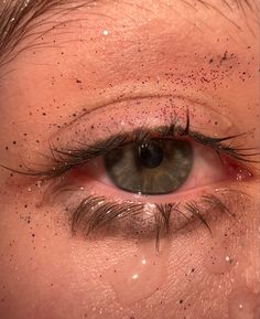 an extreme close up shot of the eye of a man with brown hair and blue eyes