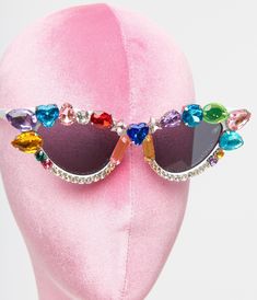 These dazzling sunglasses are set in a retro cat eye shape and accented with rainbow colored gemstones. Complete with molded nose pad. Each pair is unique and may not match images provided.Available while supplies last Disco Funk, Cat Eye Shape, Colored Gemstones, Rainbow Gemstones, Retro Cats, White Rainbow, Eye Shape, Cool Sunglasses, Eye Shapes