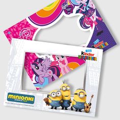 two minion stickers sitting next to each other in front of a photo frame