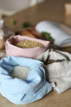 three bags filled with rice sitting on top of a table next to other food items