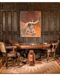 a table with chairs around it in front of a painting on the wall behind it