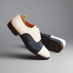 Characterized by its closed lacing style, the oxford is an elegant, classic, timeless style suitable for any occasion. The oxford is a staple shoe in any man’s wardrobe and can be dressed up or down. The Details: Materials: navy box calf + white box calf Lining: orange calf leather Sole: GOLF Last: Zurigo - Rounded toe for fraditional English Look The Fine Print: Shoe production timeline/shipping can vary from 15-30 days from the date of order. All shoes are handmade, small tinny changes or impe White Oxford Dress Shoes For Semi-formal Occasions, White Brogue Oxfords For Semi-formal Occasions, White Brogue-detailed Oxfords For Semi-formal Occasions, White Oxfords With Brogue Detailing For Semi-formal Occasions, Semi-formal White Oxfords With Brogue Detailing, White Oxford Dress Shoes For Derby, White Goodyear Welted Leather Shoes For Semi-formal Occasions, Semi-formal White Goodyear Welted Leather Shoes, White Oxford Leather Shoes With Rubber Sole