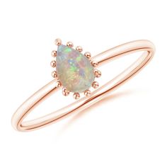 Crafted in 18k rose gold, this solitaire opal ring has a visually appealing design. Its sleek metal shank holds the iridescent cabochon opal in a prong setting. The pear-shaped gem is surrounded by a striking beaded halo. Solitaire Opal Ring, Oval Opal Ring, Opal Solitaire Ring, Halo Ring, Halo Rings, Ring Collections, Pear Shaped