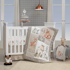 a baby crib bedding set with animals on it