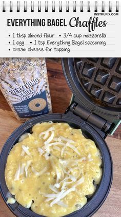 a waffle iron with cheese in it sitting on a table next to a bagel