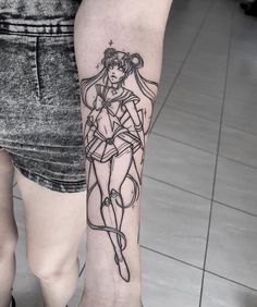 a woman's leg with a tattoo on it and an image of a sailor